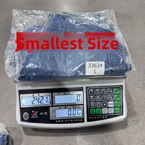 Detail view of high waist denim shorts in S size on a digital scale weighing 242.1g