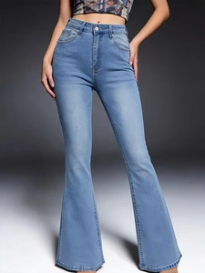 Close-up of light blue high-waisted flared jeans with washed texture and flared silhouette
