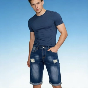 Close-up of distressed denim shorts for men with ripped details and fixed cuffed hem