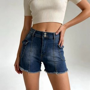 Detail of high waisted denim shorts with double button closure and utility pockets