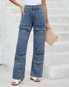 Detail view of high waisted light wash denim cargo pants with multiple side pockets