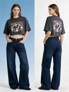 Detail of high waisted wide leg denim jeans paired with charcoal graphic crop t-shirt