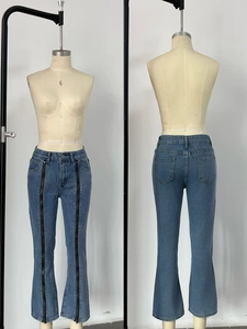 Detail of blue flare jeans featuring unique front black zippers and back pocket design