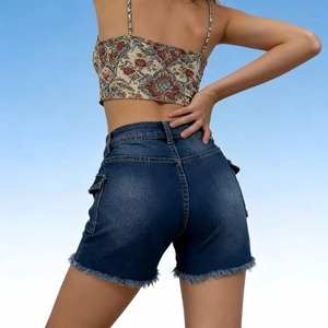 Detail showing high-waisted dark blue denim shorts with fringed hems and cargo pockets