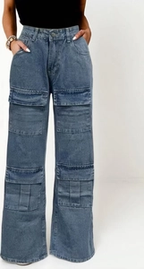Detail of vintage washed blue cargo jeans showing high waist and large utility pockets