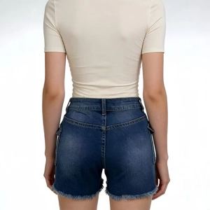 Detail view of high waist denim shorts with frayed hem and cargo pockets from the back