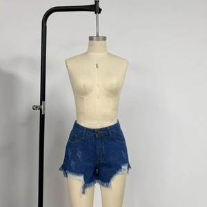 Detail view of high-waisted denim shorts featuring frayed hems and distressed ripped patterns