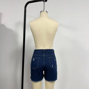 Rear view detail of dark blue denim shorts with ripped pockets and raw hem edges
