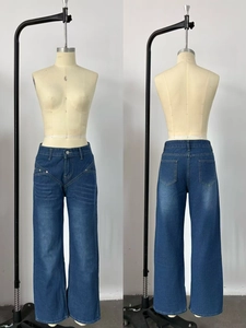 Detail view of high-waist wide-leg denim jeans with V-shaped stitching and metal rivets