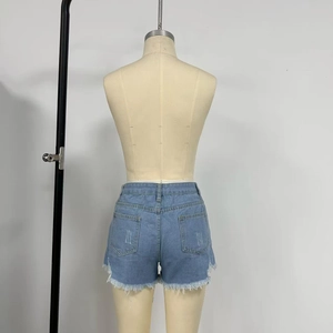 Detail view of high-waisted denim shorts featuring frayed hems and back pockets in light blue