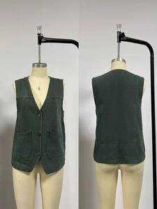Front and back detail of a dark green canvas utility vest with metal buckles and V-neck