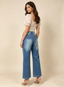 Détail d'un crop top floral à manches bouffantes et d'un jean droit taille haute pour femme