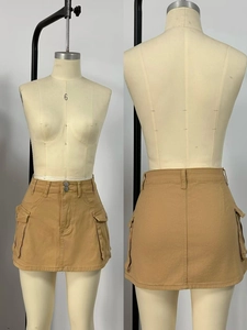 Detail view of khaki mini skirt featuring cargo pockets and double button waist closure