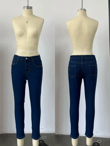Detail view of skinny stretch jeans in dark blue denim on a mannequin model