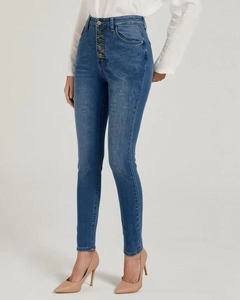 Detail of high-waisted skinny jeans featuring a stylish five-button fly and washed finish