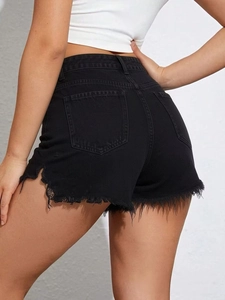 Detail view of high waist black denim shorts featuring raw fringe edges and back pockets