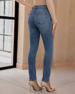 Close-up back view of light blue slim fit high-waisted jeans with classic denim pockets