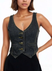 Detail of slim-fit denim vest featuring V-neckline with copper buttons and contrast stitching