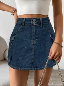 Detail of high-waist dark blue denim cargo skirt with monogram pattern and large side pockets