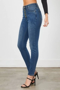 Close-up of high-waist skinny jeans featuring five-button fly and stretchy blue denim
