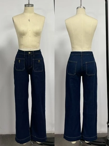 Detail view of high waist wide leg denim trousers with contrast stitching and four pockets