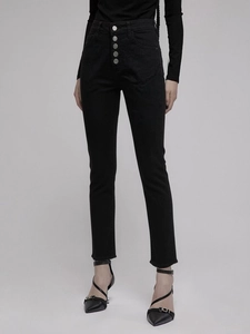 Close-up of high waist black skinny jeans with silver five-button fly and raw hem details