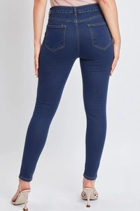 Detail of high-waist stretch skinny jeans featuring back pocket design and premium stitching