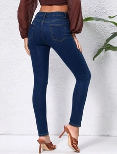 Rear view of dark blue high waisted skinny jeans featuring symmetric back pockets