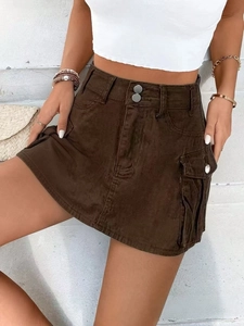 Detailed view of brown mini cargo denim skirt with dual buttons and large side pockets