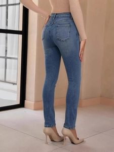 Slim fit high waisted blue denim jeans for women showing rear view and body contouring
