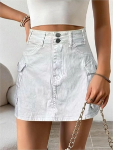 Detailed close-up of light blue cargo denim skirt featuring large flap pockets and metal buttons