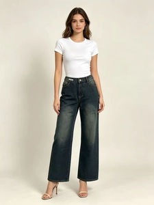 Detail of high-waisted wide-leg jeans with vintage wash and straight cut for women