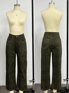 Detail view of high-waist leopard print denim jeans in dark green vintage style