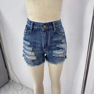 Détail de short en jean bleu foncé vieilli avec déchirures et ourlet effiloché