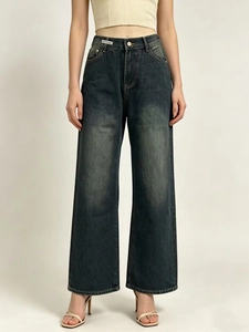 Detailed view of high-waisted wide-leg denim jeans with vintage faded wash finish