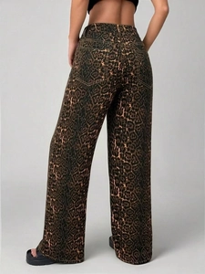 Rear view of high waisted leopard print wide leg pants with graffiti denim texture