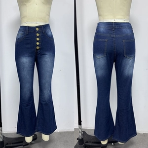 Detail of high-waisted flare jeans with five golden buttons and washed finish on blue denim