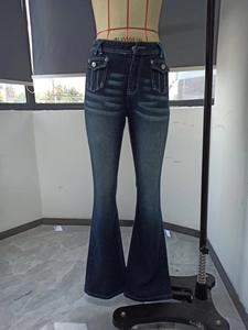 Detail of high waisted flare jeans featuring utility cargo pockets and metal buttons
