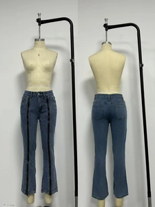 Detail view of washed blue jeans featuring unique dual front zippers and back pockets
