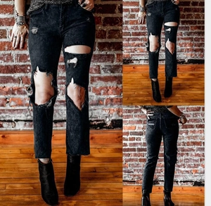 Detail showing charcoal grey ripped jeans with distressed knees and high-waist fit