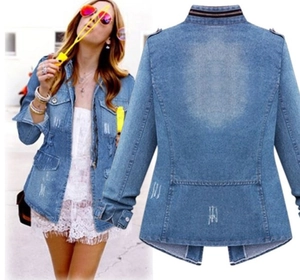 Detail of blue denim jacket with distressed texture and striped collar ribbing