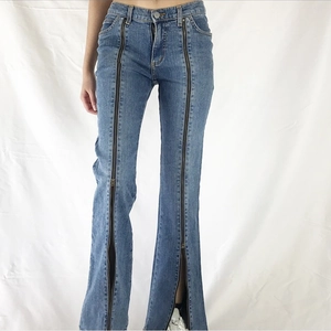 Blue washed wide leg denim jeans with full-length vertical front zippers and flared hem