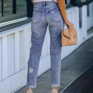 Slim fit ripped denim jeans for women with distressed details and frayed hem style