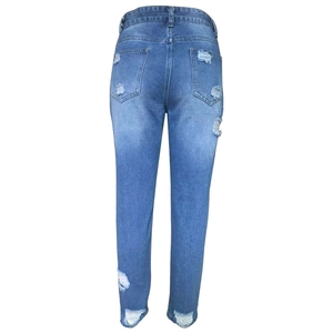 Back view of mid-blue ripped skinny jeans with distressed details and back pockets