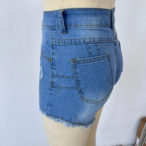 Detailed back view of high-waisted blue denim shorts featuring frayed hems and yellow stitching