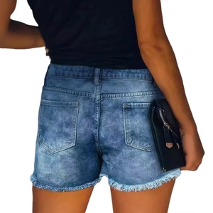 Slim fit denim shorts for women with ripped details and raw hem in medium blue wash