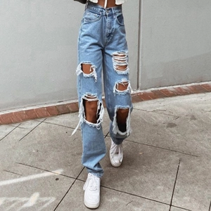 Women's high waist light blue wide leg jeans with distressed ripped details in street style