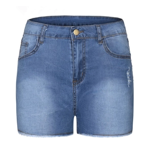 Detail of blue high waist denim shorts with fringed hems and distressed ripped effects