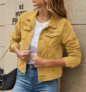 Detail of ginger yellow denim jacket showing lapel collar and metal button texture