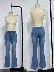 Detail showing vertical seam stitching and wave embroidery on flare denim jeans